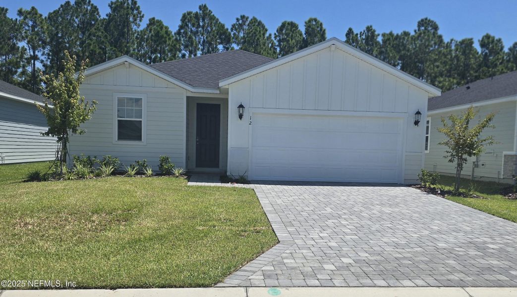Front exterior of a new home in Colbert Landings, Palm Coast, FL, highlighting curb appeal (Image 17).