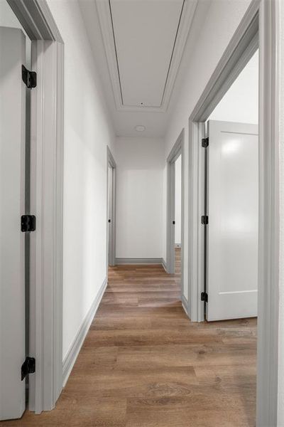 Hall featuring attic access and light wood-type flooring