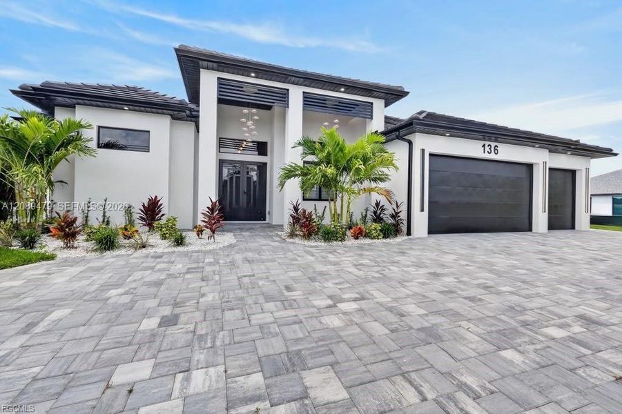 Front exterior of a new home in , Cape Coral, FL, highlighting curb appeal (Image 1). Front exterior of a new home in , Cape Coral, FL, highlighting curb appeal (Image 1).