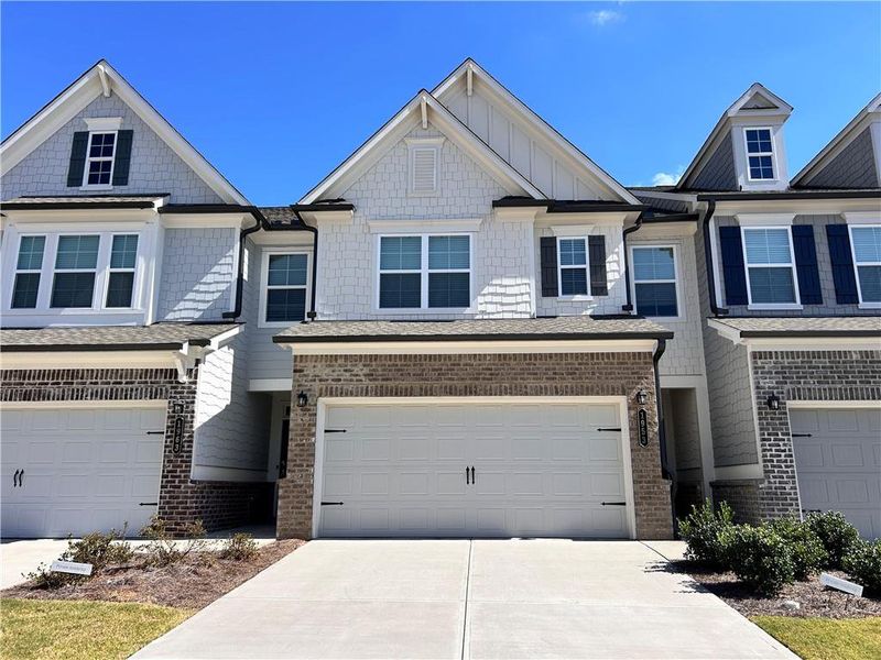 Front exterior of a new home in , Suwanee, GA, highlighting curb appeal (Image 1).