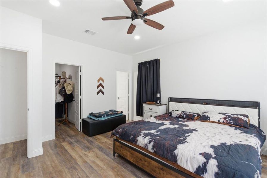 Bedroom featuring dark wood-type flooring, a spacious closet, recessed lighting, and ceiling fan Bedroom featuring dark wood-type flooring, a spacious closet, recessed lighting, and ceiling fan
