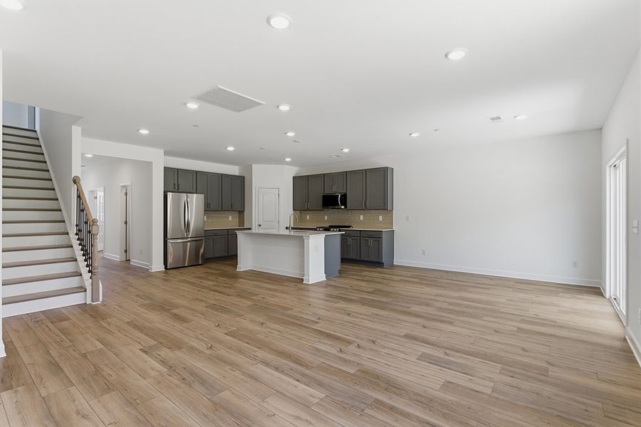 A large kitchen with wood floors. A large kitchen with wood floors.