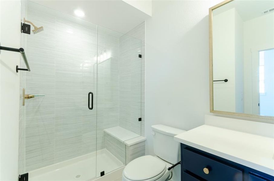 Bathroom featuring vanity and a stall shower