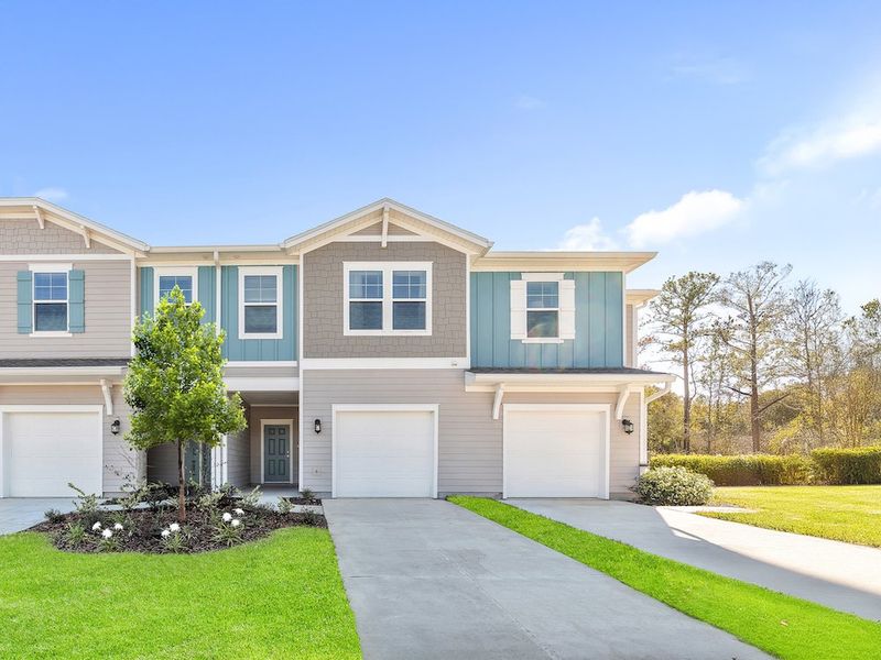 Front exterior of a new home in Silver Falls Townhomes at Silverleaf, St. Augustine, FL, highlighting curb appeal (Image 1).