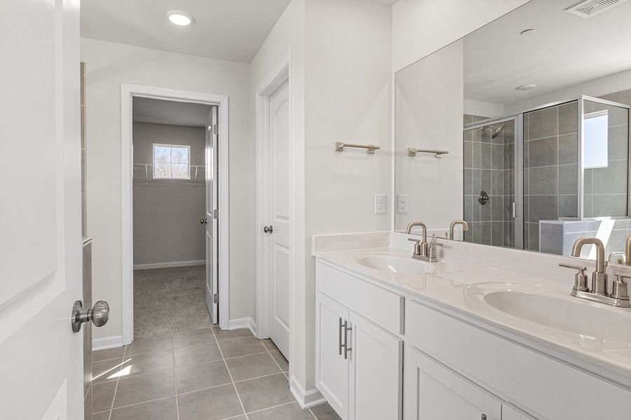 A bathroom with a large mirror. A bathroom with a large mirror.