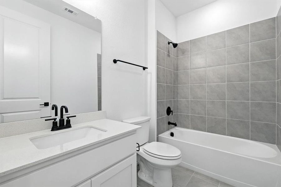 Bathroom 1 on first floor. Quartz counter, full tub and shower combination. Lots of lighting.