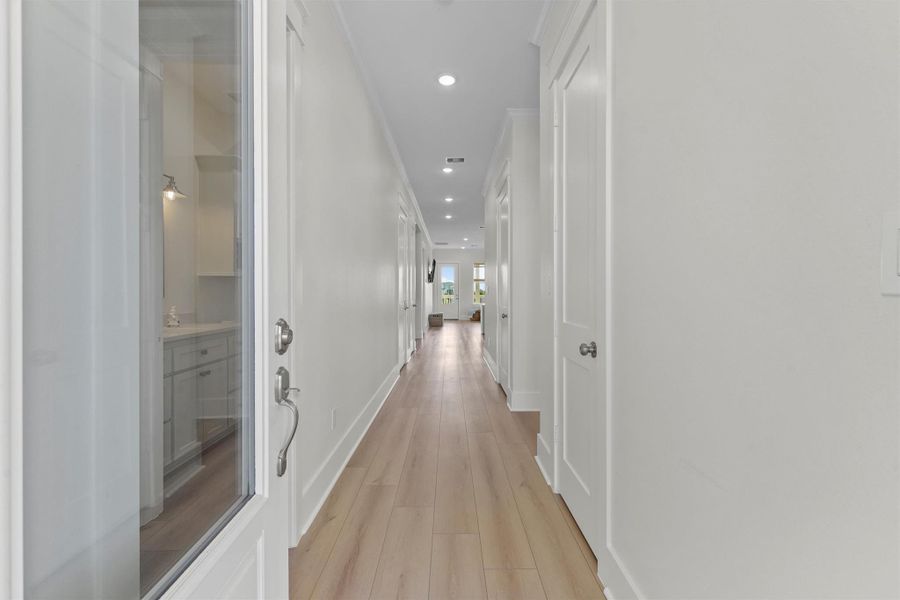 Step inside to a light-filled hallway with stylish wood-look vinyl flooring and clean coastal finishes that guide you straight to the heart of the home. Step inside to a light-filled hallway with stylish wood-look vinyl flooring and clean coastal finishes that guide you straight to the heart of the home.