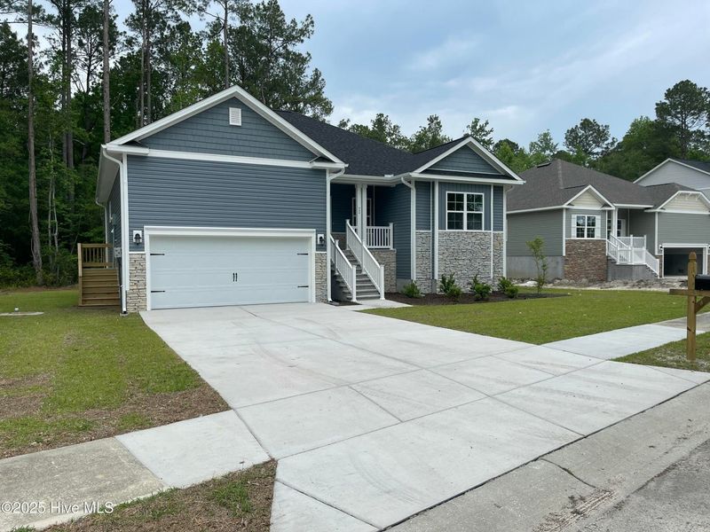 Front exterior of a new home in Mill Creek Cove, Bolivia, NC, highlighting curb appeal (Image 2).