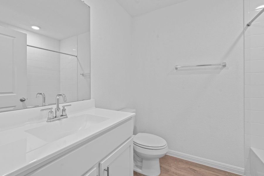 Full bath featuring light wood-type flooring, vanity, and  shower combination