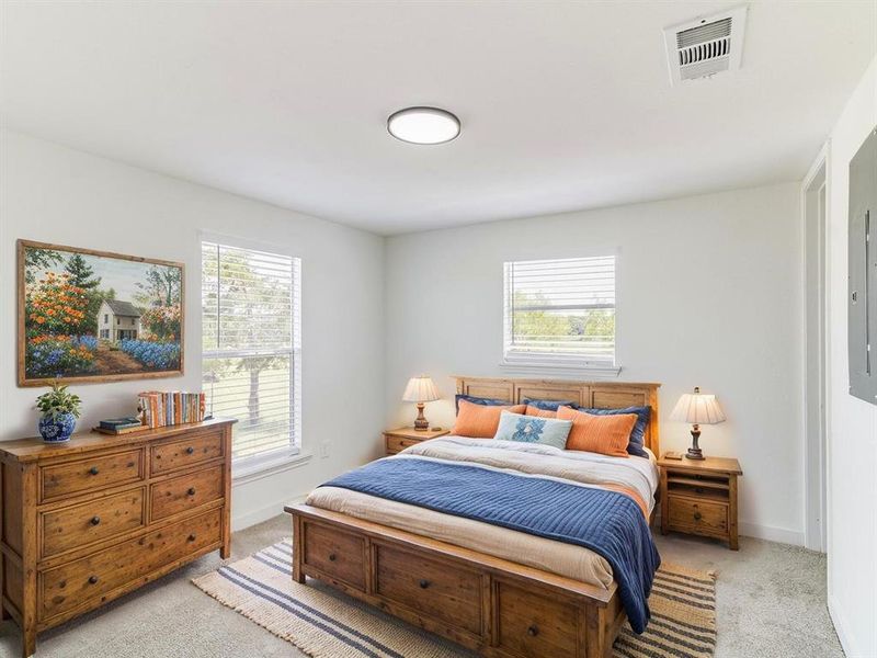 Bedroom with light carpet and baseboards Bedroom with light carpet and baseboards