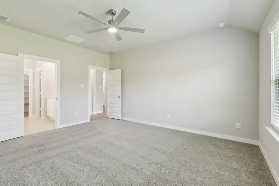 Primary Suite in the Heisman home plan by Trophy Signature Homes – REPRESENTATIVE PHOTO
