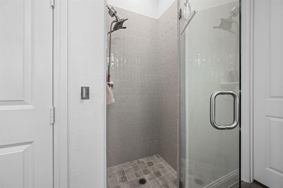 Shower with a frameless glass door. Shower with a frameless glass door.