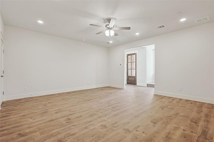 Spare room with ceiling fan and light hardwood / wood-style flooring