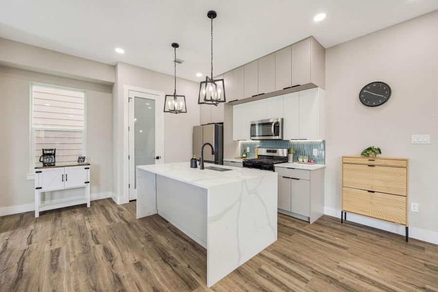 Light-filled open-concept living with a spacious island, quartz countertops, and seamless flow for everyday living. Light-filled open-concept living with a spacious island, quartz countertops, and seamless flow for everyday living.