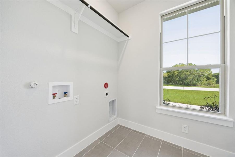 Washroom featuring tile patterned flooring, electric dryer hookup, hookup for a washing machine, and gas dryer hookup