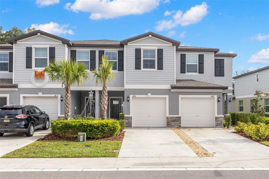 Front exterior of a new home in , Land O' Lakes, FL, highlighting curb appeal (Image 1). Front exterior of a new home in , Land O' Lakes, FL, highlighting curb appeal (Image 1).