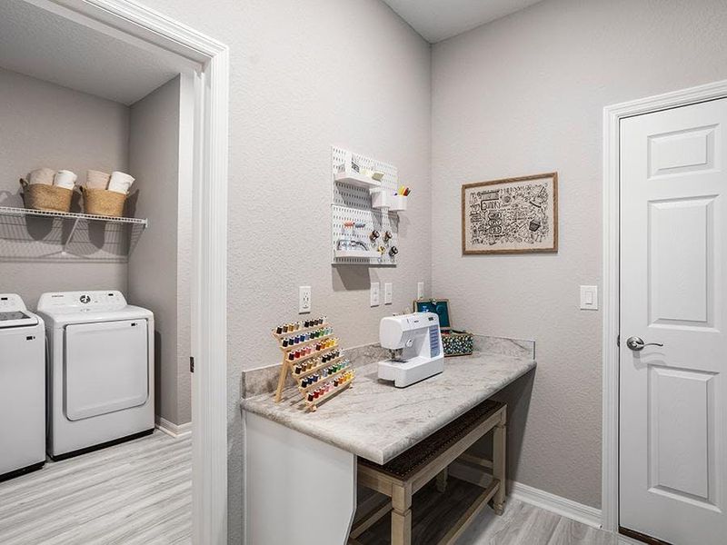 Convenient mudroom and dedicated laundry room near garage entrance - Aubrey home plan by Highland Homes