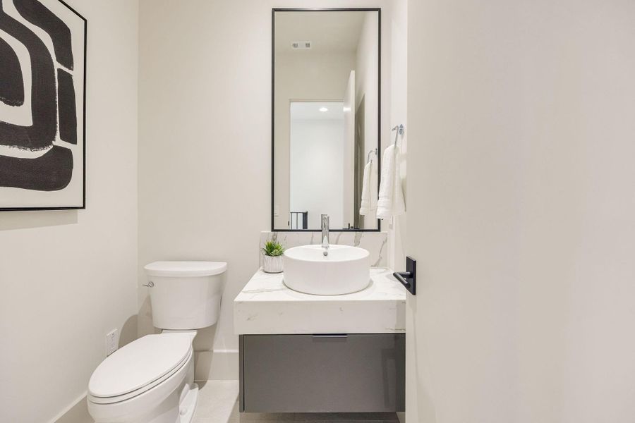 [POWDER RM-2ND FLR] A stylish second-floor powder room showcases designer finishes, sleek contemporary lines, and elegant details, offering both style and convenience for guests.