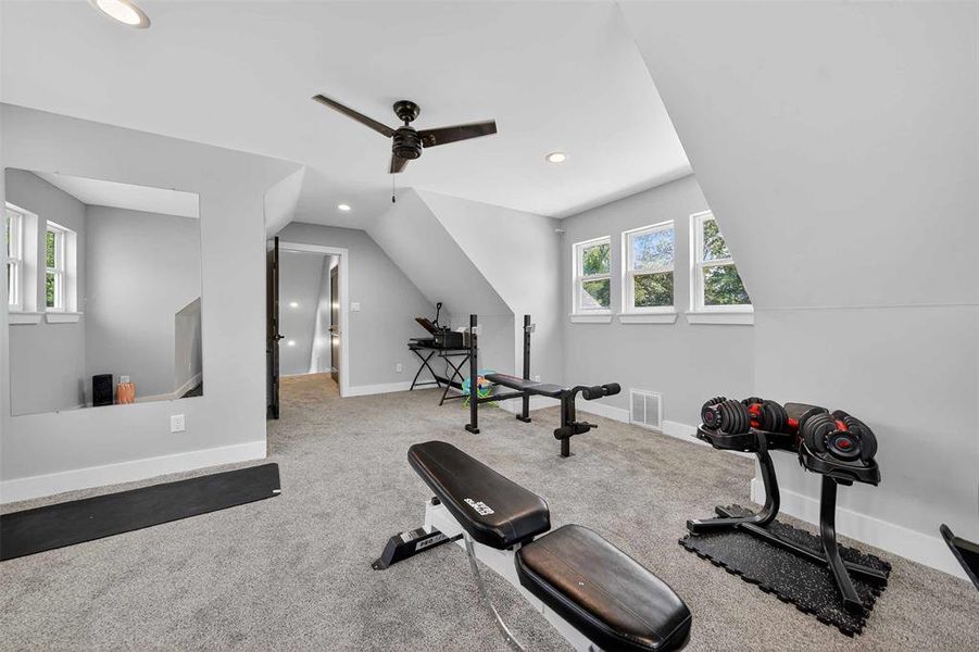 Exercise room with recessed lighting, light colored carpet, ceiling fan, and vaulted ceiling Exercise room with recessed lighting, light colored carpet, ceiling fan, and vaulted ceiling