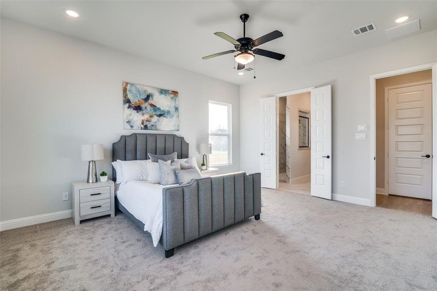 Bedroom featuring ceiling fan and light carpet