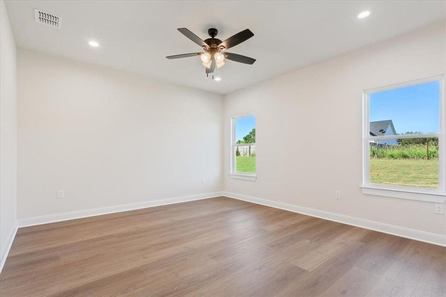 Empty room featuring light wood finished floors, recessed lighting, and ceiling fan