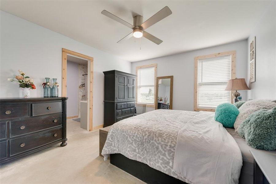 Bedroom with light carpet and a ceiling fan