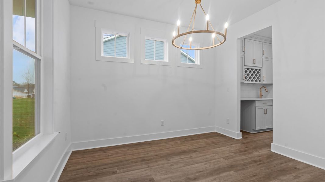 Elegant coffered ceiling sets the tone in this tasteful, entertaining-ready dining room