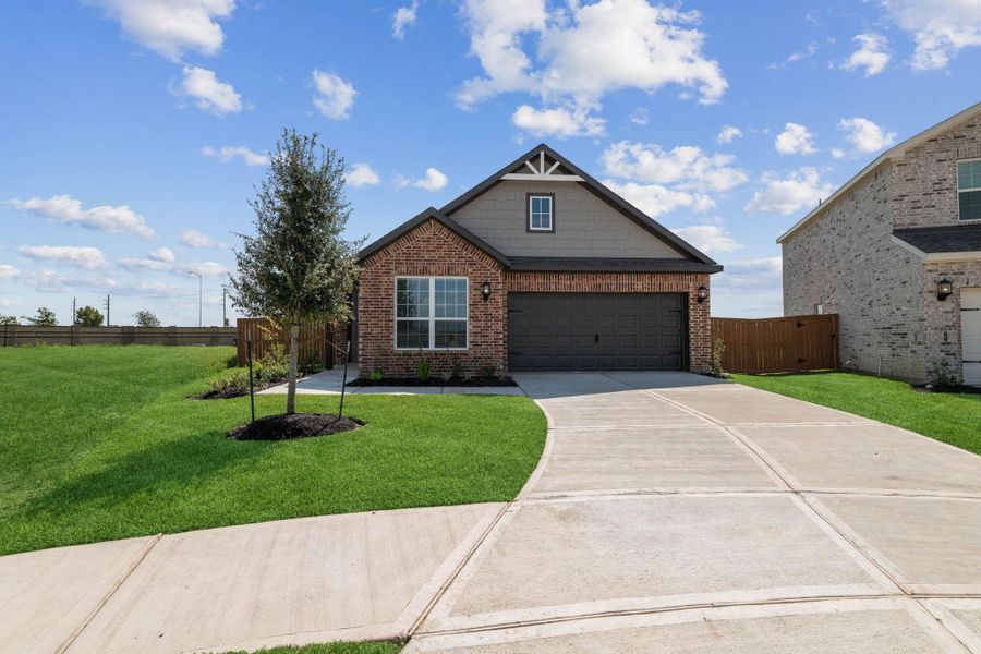 Front exterior of a new home in Emberly, Beasley, TX, highlighting curb appeal (Image 1).