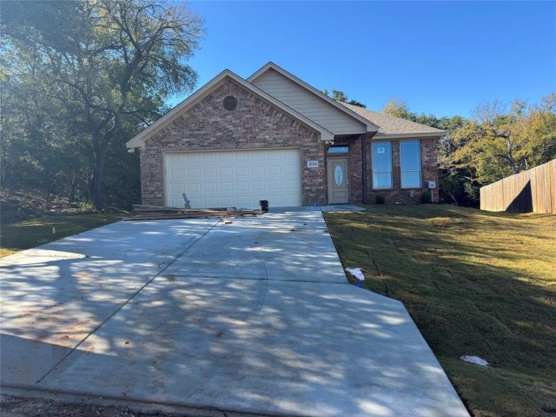 Front exterior of a new home in , Granbury, TX, highlighting curb appeal (Image 1).