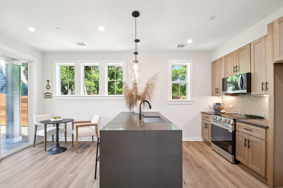 A well-appointed kitchen features a large island and ample cabinet space, bathed in natural light. A well-appointed kitchen features a large island and ample cabinet space, bathed in natural light.