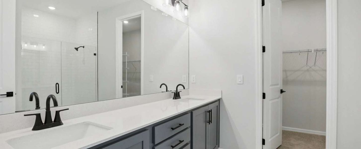 Primary bathroom with double sinks and a walk-in shower will feature aspects of AW Collection® Sapphire - Representative images and renderings are for illustrative purposes