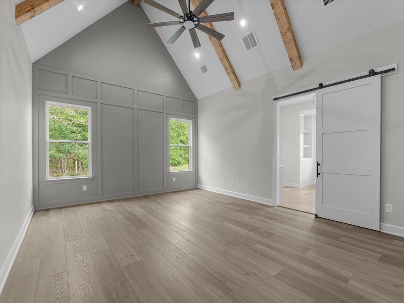 Beautiful primary suite with high ceilings.