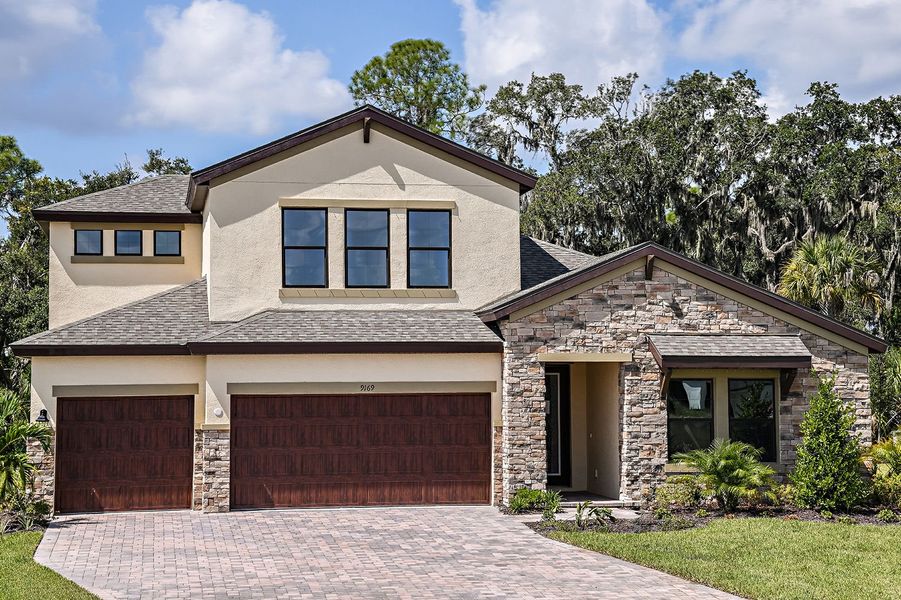 Representative exterior photo of a completed home built from the Hyde Park IV by Homes by WestBay in Caldera, Spring Hill, FL (Image 4).