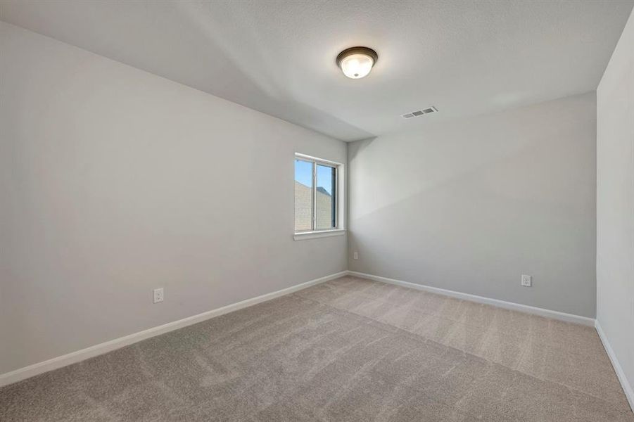 Carpeted empty room featuring baseboards