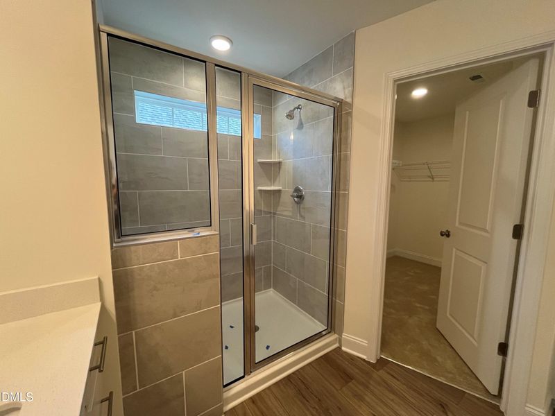 Spacious walk in tiled shower with bench