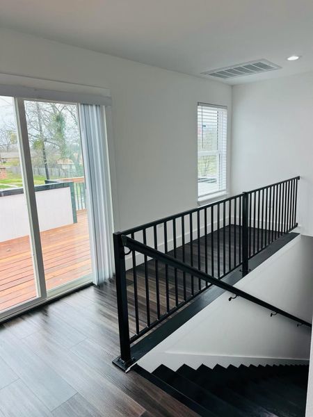 Stairway featuring wood finished floors Stairway featuring wood finished floors