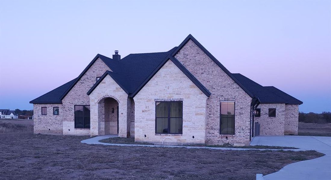 View of front of property with brick siding and a chimney View of front of property with brick siding and a chimney
