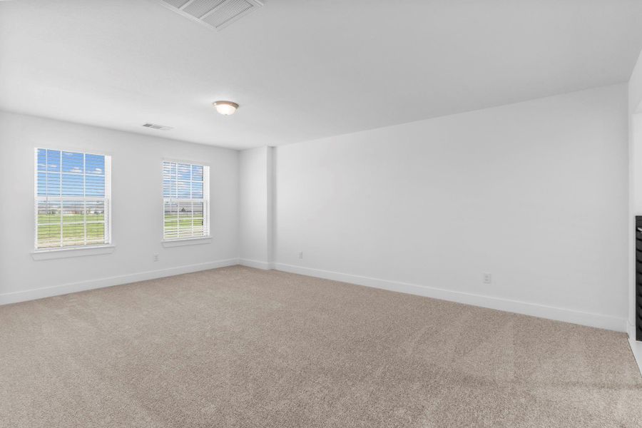 Expansive game room with ample space for a pool table, media center, or play area — a perfect gathering spot for fun and relaxation. Expansive game room with ample space for a pool table, media center, or play area — a perfect gathering spot for fun and relaxation.