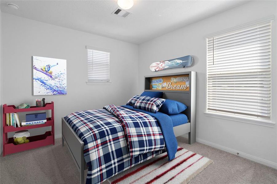 Secondary bedroom features plush carpet, neutral paint, lighting, large window with privacy blinds and ample sized closet space.