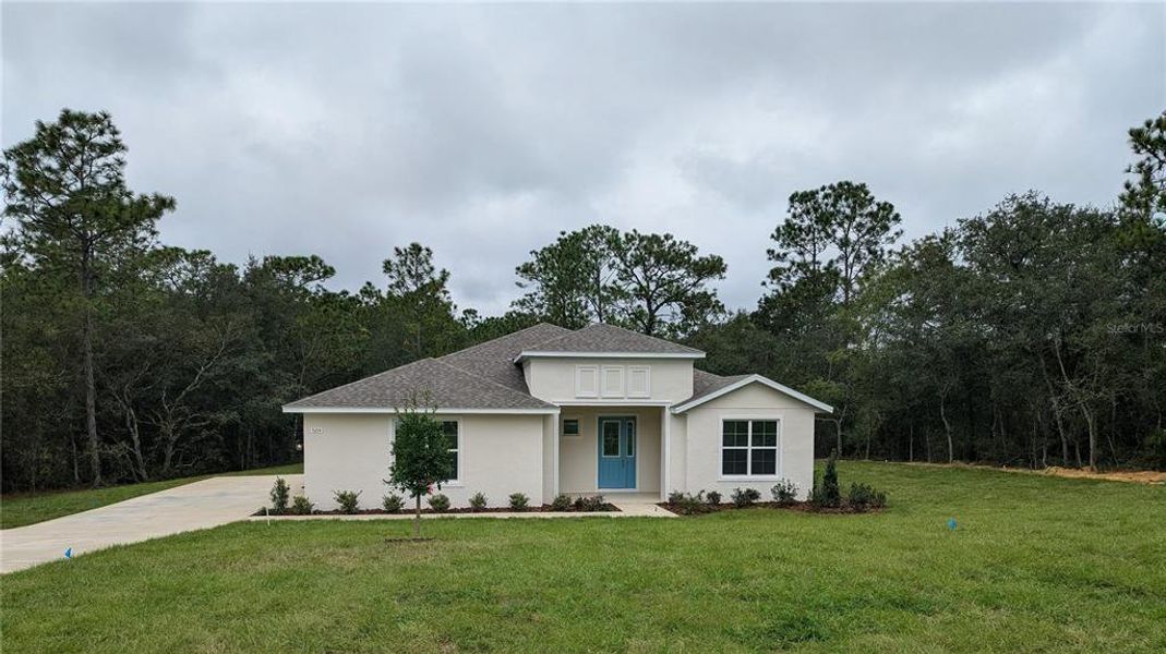 Front exterior of a new home in Pine Ridge Estates, Beverly Hills, FL, highlighting curb appeal (Image 1). Front exterior of a new home in Pine Ridge Estates, Beverly Hills, FL, highlighting curb appeal (Image 1).