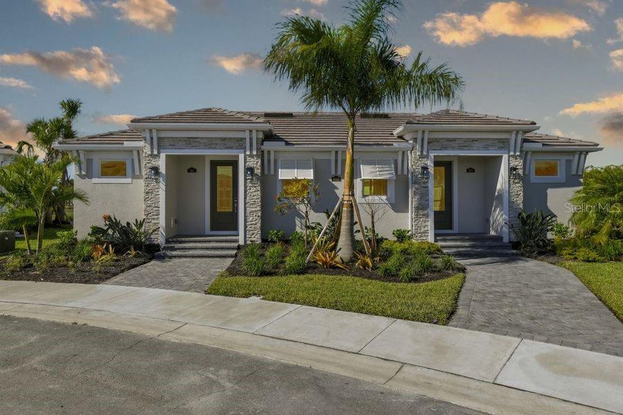 Front exterior of a new home in Esplanade at Azario Lakewood Ranch, Bradenton, FL, highlighting curb appeal (Image 1). Front exterior of a new home in Esplanade at Azario Lakewood Ranch, Bradenton, FL, highlighting curb appeal (Image 1).