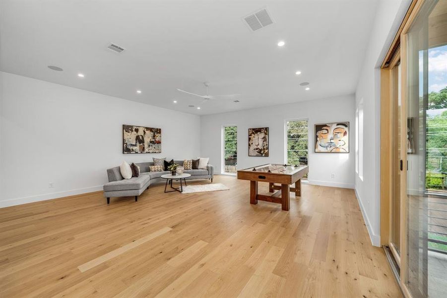 Rec room with recessed lighting, light wood finished floors, and a ceiling fan