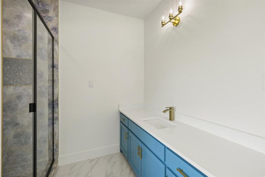 Bathroom featuring vanity and walk in shower