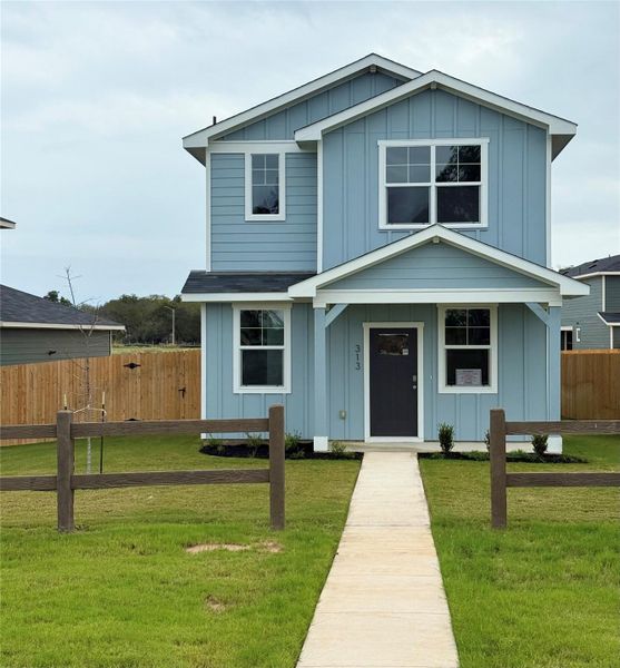 Front exterior of a new home in Valverde, Bastrop, TX, highlighting curb appeal (Image 1).