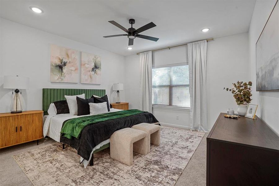 Bedroom with light colored carpet and ceiling fan