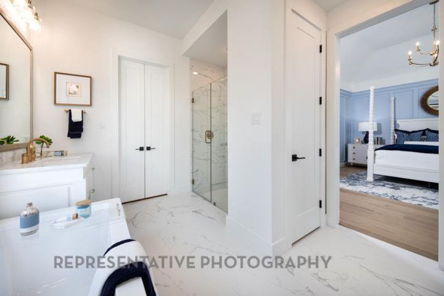 Ensuite bathroom with a marble finish shower, ensuite bath, a chandelier, marble finish floor, and vanity Ensuite bathroom with a marble finish shower, ensuite bath, a chandelier, marble finish floor, and vanity