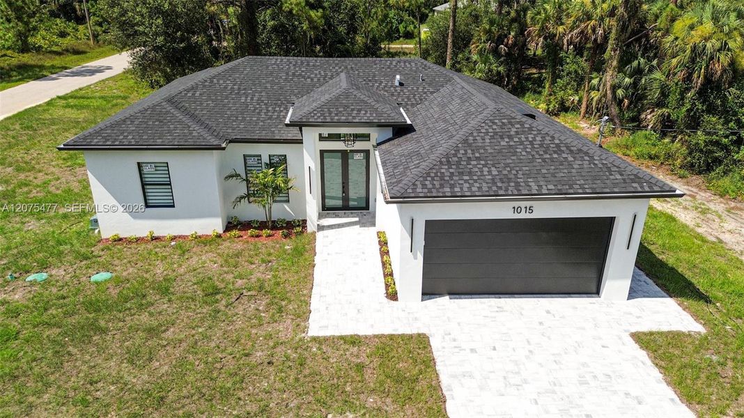 Front exterior of a new home in , Lehigh Acres, FL, highlighting curb appeal (Image 37). Front exterior of a new home in , Lehigh Acres, FL, highlighting curb appeal (Image 37).