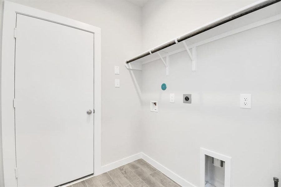 Located on first floor, a stylish laundry room where practicality meets a contemporary aesthetic. The dark finishes lend a sophisticated touch, creating a space that is both functional and visually appealing. Both electric and gas connections available.