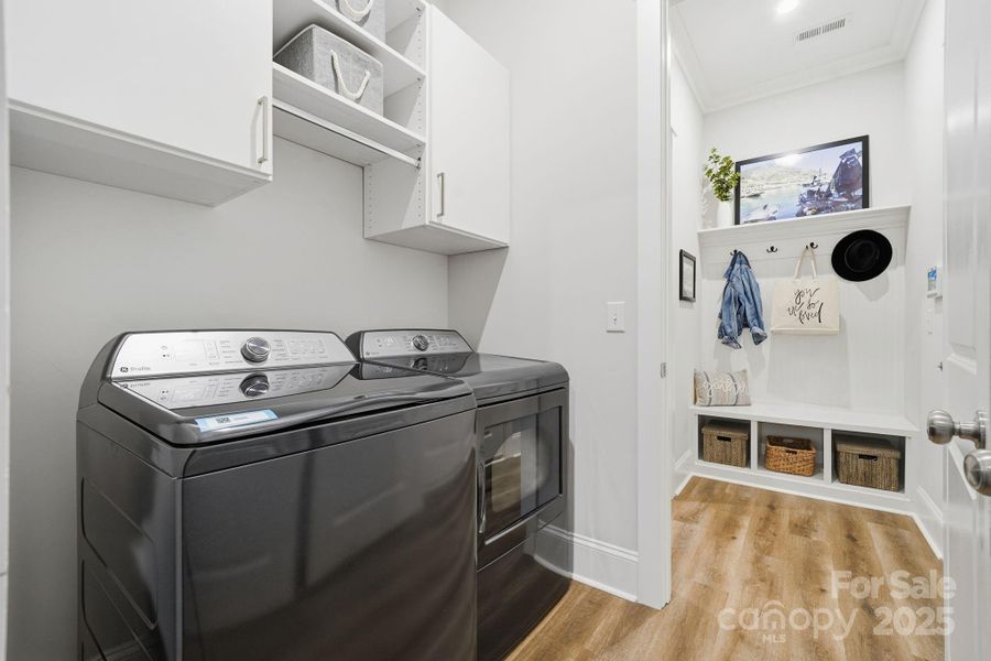 Laundry off primary closet with upgraded custom cabinets