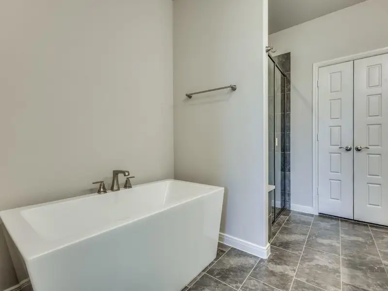 You'll find a spacious walk in shower and relaxing free standing tub in this owner's bath. You'll find a spacious walk in shower and relaxing free standing tub in this owner's bath.